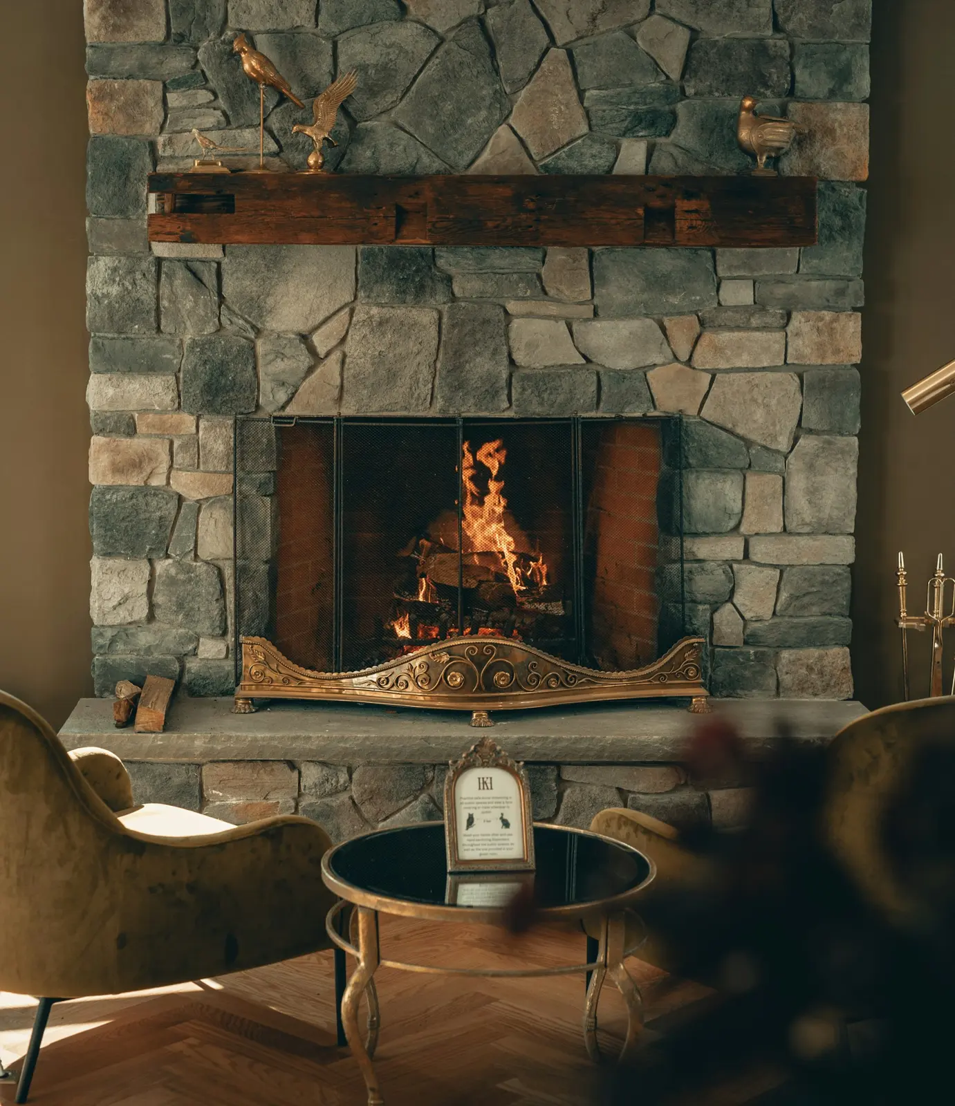 Living room with a stone wood-burning fireplace